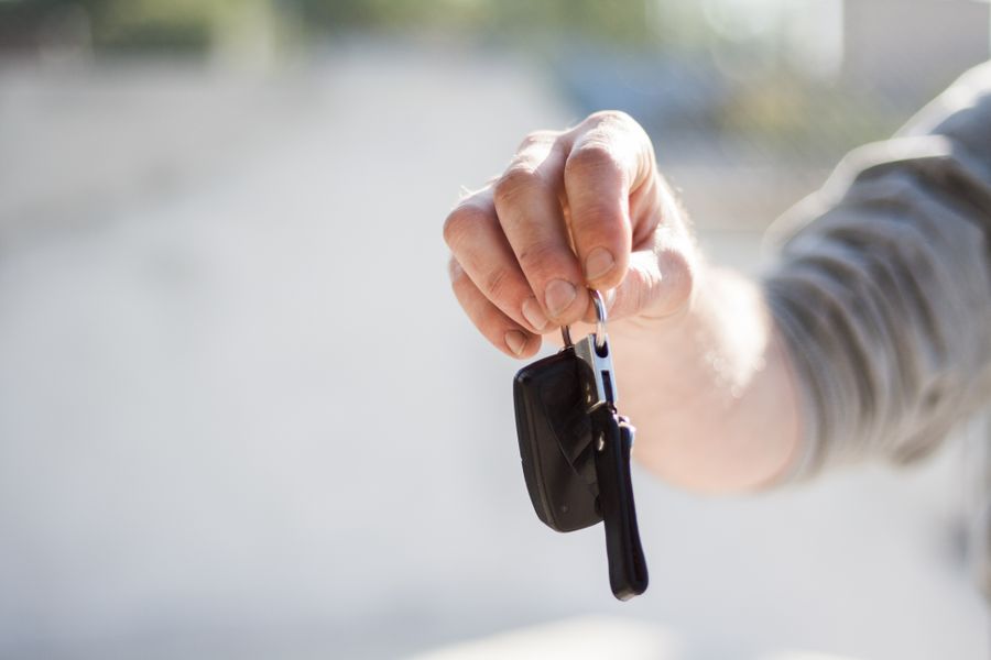 Hand passing over car keys