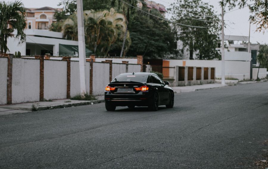 Car driving down a quiet suburban street